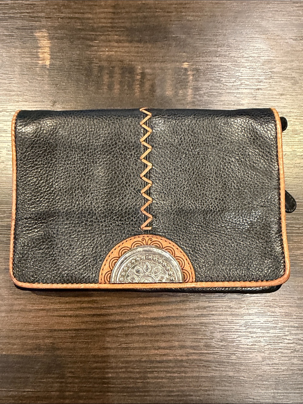Brighton Black Leather Crossbody with Brown Trim and Decorative Medallion